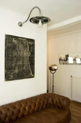 a couch in a room with a map on the wall at Appartement Cannes rue Marceau in Cannes
