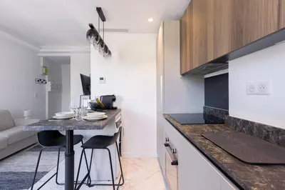 a small kitchen with a table in a room at Studio Jules - Bd de Lorraine in Cannes