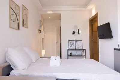 a bedroom with a white bed with towels on it at Studio Jules - Bd de Lorraine in Cannes