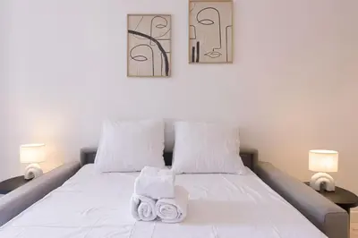 a bedroom with a white bed with towels on it at Studio Jules - Bd de Lorraine in Cannes