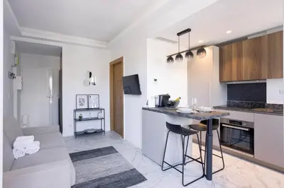 a kitchen with white walls and a counter top at Studio Jules - Bd de Lorraine in Cannes