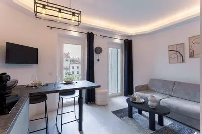 a living room with a couch and a table at Studio Charlie - Bd de Lorraine in Cannes