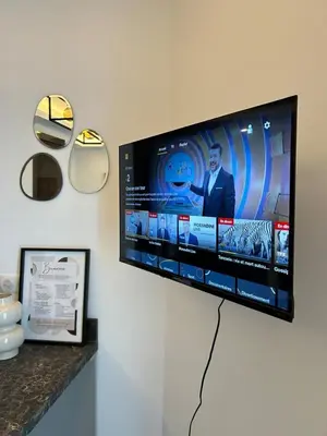 a flat screen tv hanging on a wall at Studio Charlie - Bd de Lorraine in Cannes