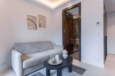 a living room with a couch and a table at Studio Charlie - Bd de Lorraine in Cannes