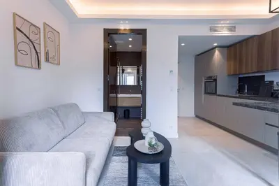 a living room with a couch and a table at Studio Charlie - Bd de Lorraine in Cannes