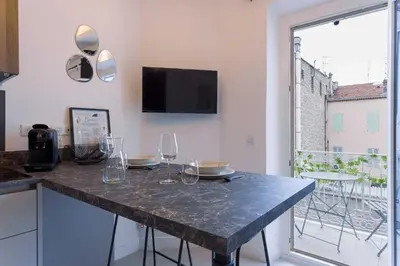 a kitchen with a table with wine glasses on it at Studio Charlie - Bd de Lorraine in Cannes