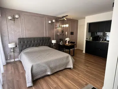 a bedroom with a bed and a kitchen at Modern studio in the hearth of Cannes just a few steps from the Croisette beach front and shops - 2242 in Cannes