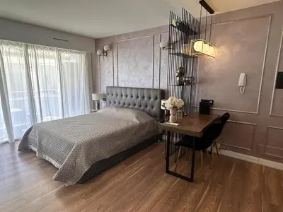 a bedroom with a bed and a table and a desk at Modern studio in the hearth of Cannes just a few steps from the Croisette beach front and shops - 2242 in Cannes