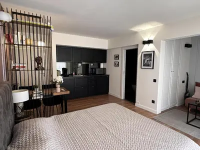 a living room with a bed and a kitchen at Modern studio in the hearth of Cannes just a few steps from the Croisette beach front and shops - 2242 in Cannes