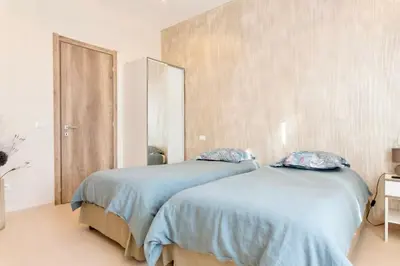 two beds sitting next to each other in a bedroom at 3 ROOMS - DOWNTOWN CANNES - 2 MIN FROM PALAIS Festivals in Cannes