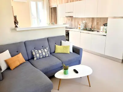 a living room with a blue couch and a table at 3 ROOMS - DOWNTOWN CANNES - 2 MIN FROM PALAIS Festivals in Cannes