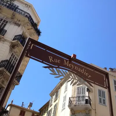 a street sign in front of a building at 3 ROOMS - DOWNTOWN CANNES - 2 MIN FROM PALAIS Festivals in Cannes