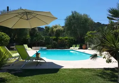 a swimming pool in front of a house at Spacious Villa Vallauris Cannes with AC throughout and large private pool in Vallauris