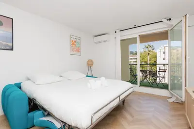 a large bed with two pillows on top of it at Appartement 3 pièces, parking, 6mn de la Croisette in Cannes