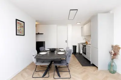 a living room with a couch and a table and a tv at Appartement 3 pièces, parking, 6mn de la Croisette in Cannes