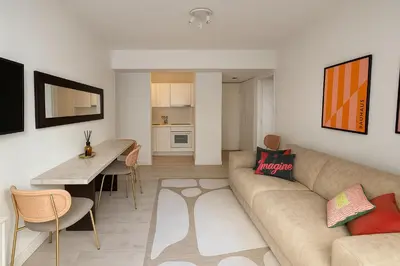 a living room with a couch and a table at Appartement terrasse Croisette in Cannes
