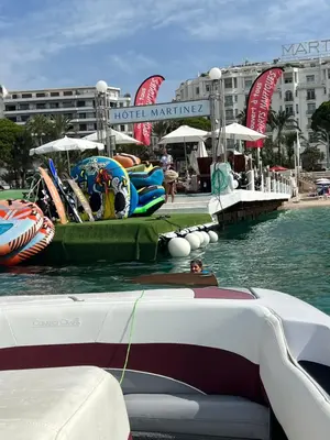 a boat in the water next to a resort at Appartement terrasse Croisette in Cannes