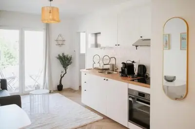 a white kitchen with a sink and a counter at LA BELLE PLAGE près de la plage du Midi, Palais des Festivals et centre-ville in Cannes