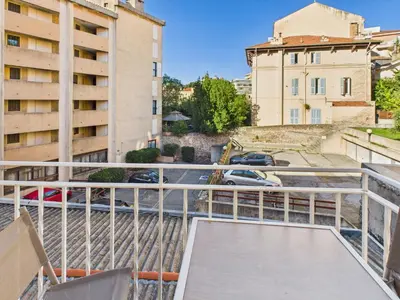a balcony with a view of a street and buildings at LA BELLE PLAGE près de la plage du Midi, Palais des Festivals et centre-ville in Cannes