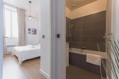 a bathroom with a tub and a bedroom with a bed at 