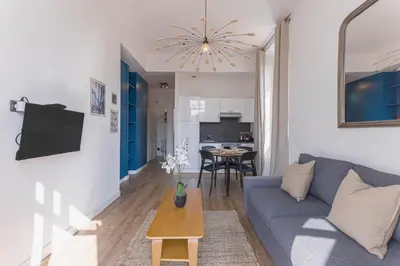 a living room with a blue couch and a table at 