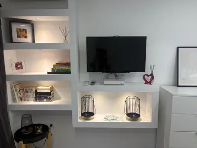 a white shelf with a flat screen tv on top of it at studio Pointe Croisette avec terrasse in Cannes