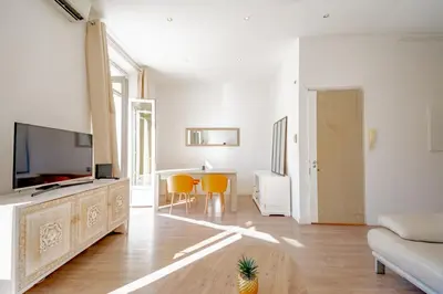a living room with a television and a table at Bel appartement avec balcon centre ville in Cannes