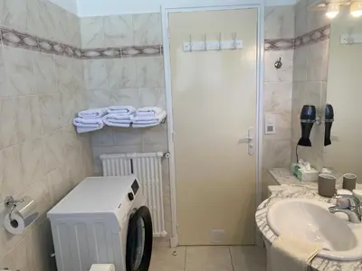a bathroom with a washing machine and a sink at Charming apartment in the centre of Cannes in Cannes