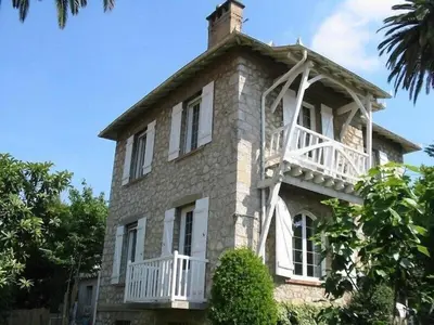 a large brick building with a balcony on top of it at Villa 12MN Walk from le palais in Cannes