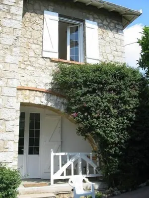 a stone house with a white door and a window at Villa 12MN Walk from le palais in Cannes