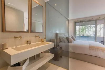 a bathroom with a sink and a bed and a mirror at La Réale Croisette in Cannes