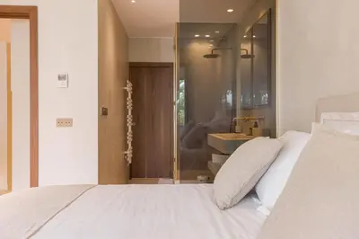 a bedroom with a white bed and a sink at La Réale Croisette in Cannes