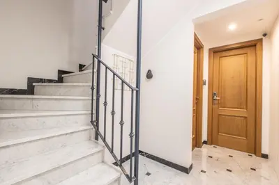 a hallway with stairs and a wooden door at LB Vacation Rentals I Superieure Room 22m2 - Spacious I Casa d'Azur in Cannes
