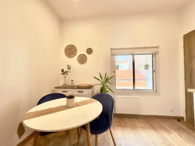 a room with a table and chairs and a window at Rêve Bleu By SCLS Locations in Cannes