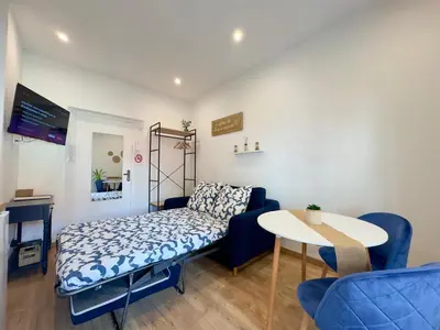 a small room with a bed and a table at Rêve Bleu By SCLS Locations in Cannes