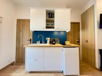 a kitchen with white cabinets and a sink at Rêve Bleu By SCLS Locations in Cannes