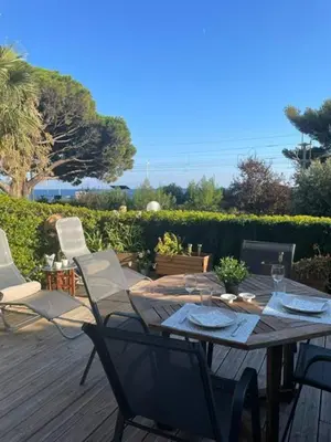 a wooden table and chairs on a wooden deck at Cannes in Cannes