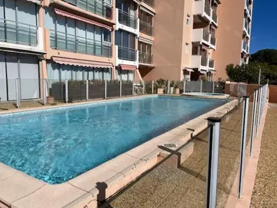 a large swimming pool in front of a building at Cannes in Cannes