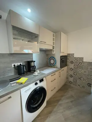 a kitchen with a washer and a washing machine at Cannes in Cannes
