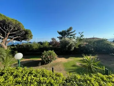 a garden with trees and bushes and a fence at Cannes in Cannes