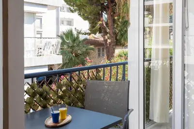 a table and chair on a balcony with a view at Bright 1-Br Apartment Walk to the Beach in Cannes