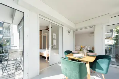 a dining room with a table and chairs at Bright 1-Br Apartment Walk to the Beach in Cannes