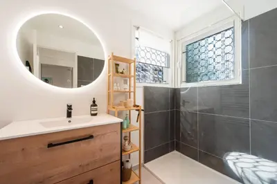 a bathroom with a sink and a shower at Bright 1-Br Apartment Walk to the Beach in Cannes