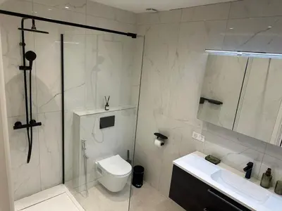 a bathroom with a shower and a toilet and a sink at Golden House Cannes in Cannes