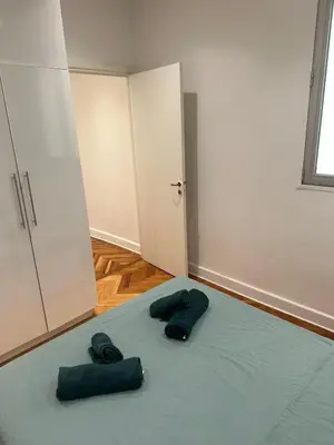 a room with two green pillows on a bed at Golden House Cannes in Cannes