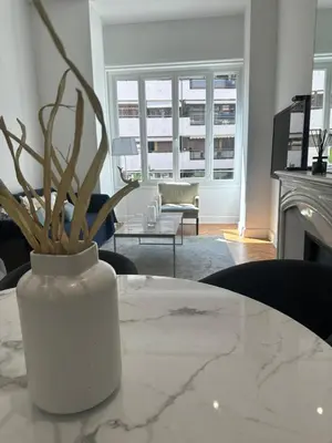 a white vase sitting on a table in a living room at Golden House Cannes in Cannes