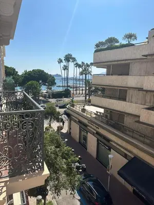 a balcony of a building with a car on a street at Golden House Cannes in Cannes