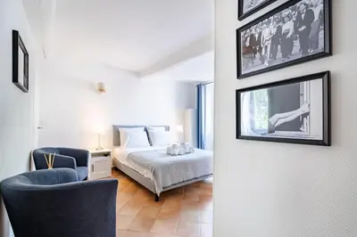 a bedroom with a bed and a chair at Confortable appartement - Cannes centre le Suquet in Cannes