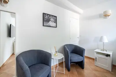 a living room with two chairs and a table at Confortable appartement - Cannes centre le Suquet in Cannes