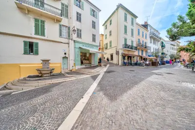 a cobblestone street in a city with buildings at Confortable appartement - Cannes centre le Suquet in Cannes